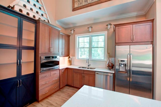 Kitchen in Raleigh clubhouse with contrasting cabinets and large accessory