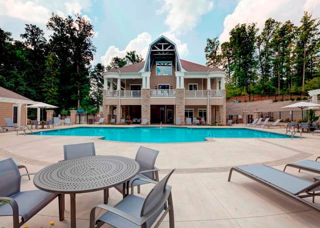 Exterior back of Raleigh Hamptons style clubhouse, showing pool and pool deck