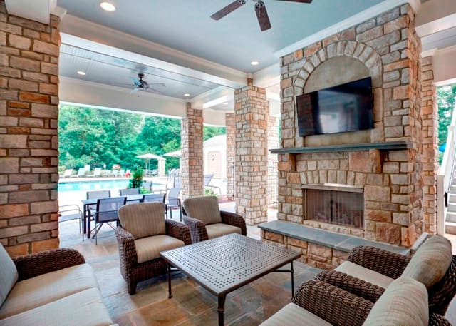 Outdoor Living Area at Raleigh Clubhouse with outdoor fireplace, overlooking pool