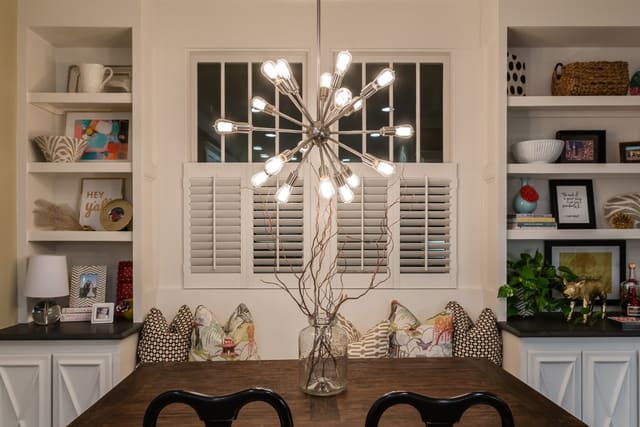 Breakfast Nook with funky chandelier, bench seating, and accessorized built-ins.