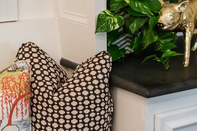 Close-up of fun pillows and brass pig accessory