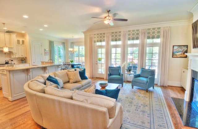 Raleigh (ITB) Family Room with Faux Roman shades and drapery panels, wool area rug, custom curved sectional and pair of chairs