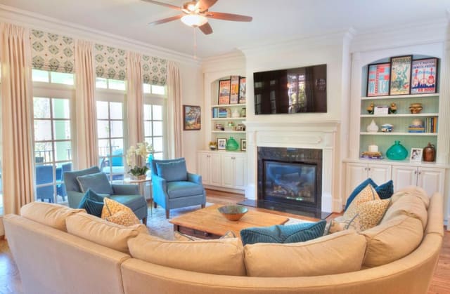 Raleigh (ITB) Family Room with accessorized built-ins, Faux Roman shades and drapery panels, custom curved sectional and pair of chairs