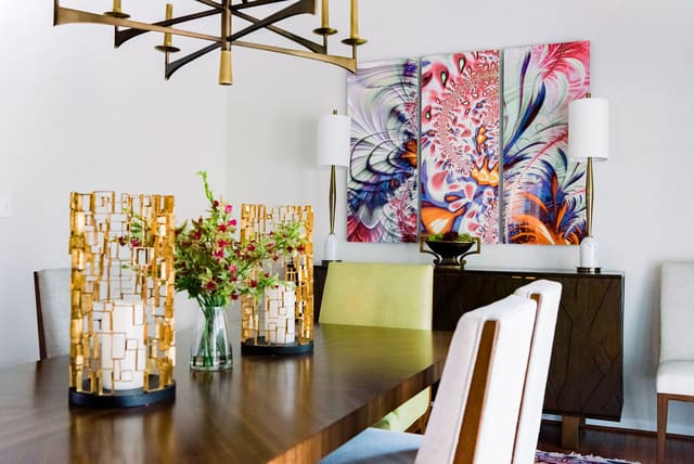 Close up of dining room table with vibrant art in background.