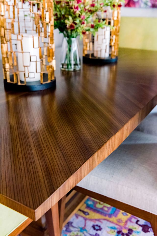 Close-up of dining table with unique wood grain showing through finish.