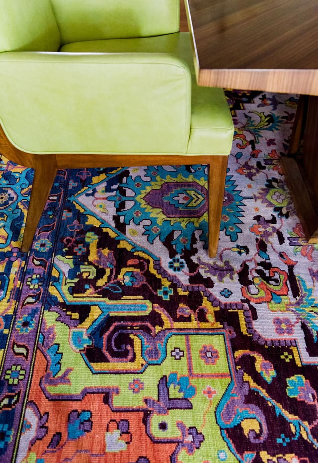 Close-up of colorful Dining Room rug and CItron leather dining chair.