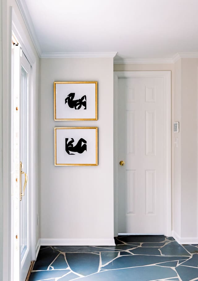 Abstract artwork pairs perfectly with these original slate floors in this remodeled Breakfast Room.