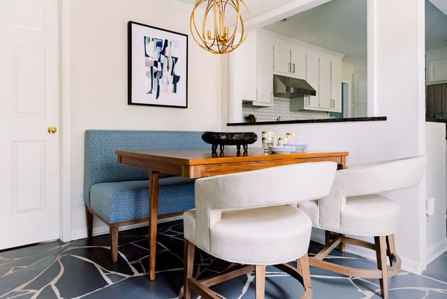 Unique Breakfast Room in Mid-Century Modern home - featuring modified 3-legged table, dining bench, modern dining chairs and modern artwork.