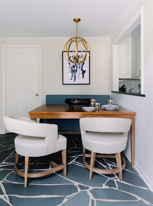 Unique Breakfast Room in Mid-Century Modern home - featuring modified 3-legged table, dining bench, modern dining chairs and modern artwork.