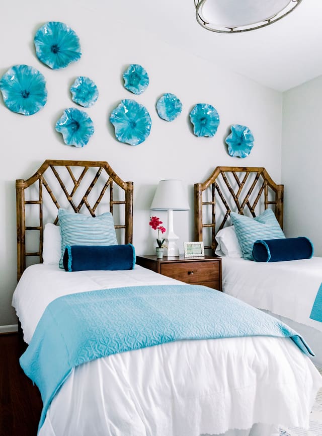 Guest Bedroom with Twin Chinese Chippendale headboards with aqua ceramic flowers on wall above.