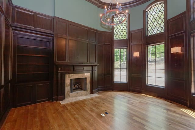 Study in Raleigh home with 2 story ceiling and dark wood panelling