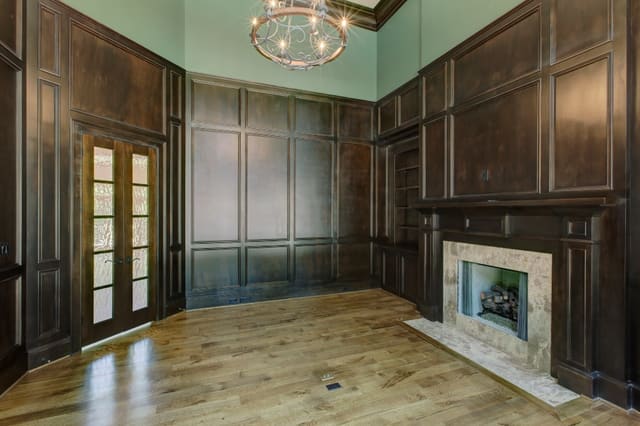 Study in Raleigh home with 2 story ceiling and dark wood panelling