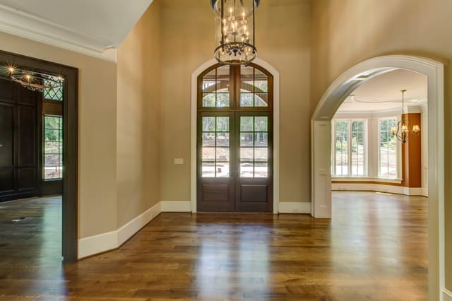 Foyer in Raleigh Home, Front Door with windows and arched entrance into Dining Room