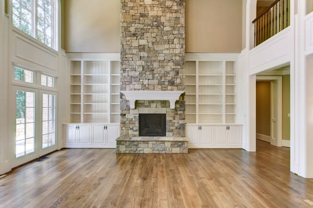 Living Room of Raleigh Home with 2-story stone fireplace and built-in bookshelves