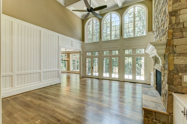 Living Room of Raleigh Home with white wood paneling and arched windows