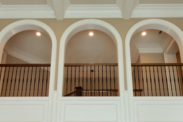 View of indoor balcony with arched openings in Raleigh home