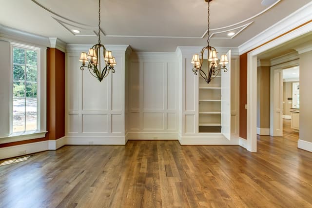 Dining Room in Raleigh Home with decorative ceiling, twin chandeliers, and hidden shelves