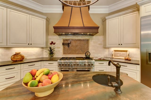 Raleigh Kitchen with custom range hood, tile backsplash and pot-filler