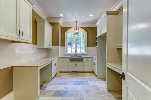 Laundry Room in Raleigh home with tile floors and white subway tile