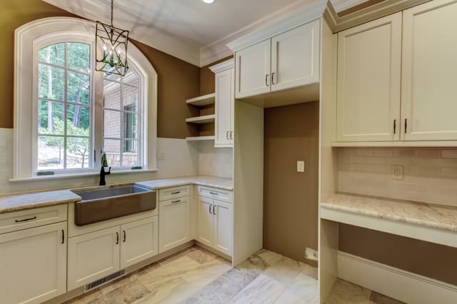 Laundry Room in Raleigh home with tile floors and white subway tile backsplash