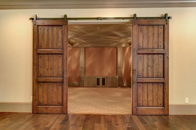 Barn style doors on track looking into Theater Room in Raleigh home