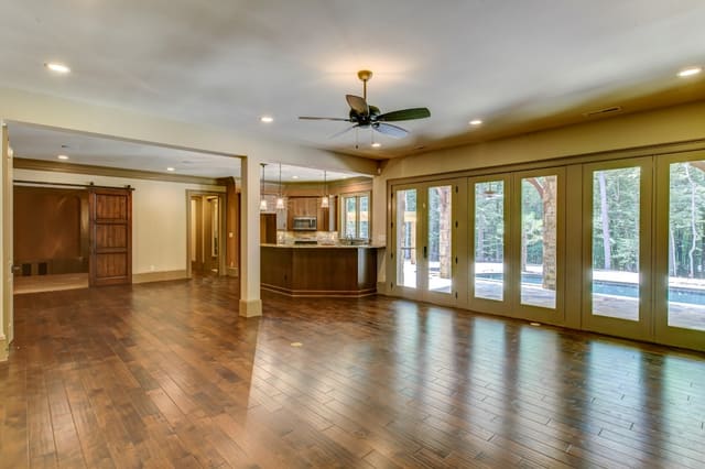 Basement of Raleigh home with widows looking out to pool