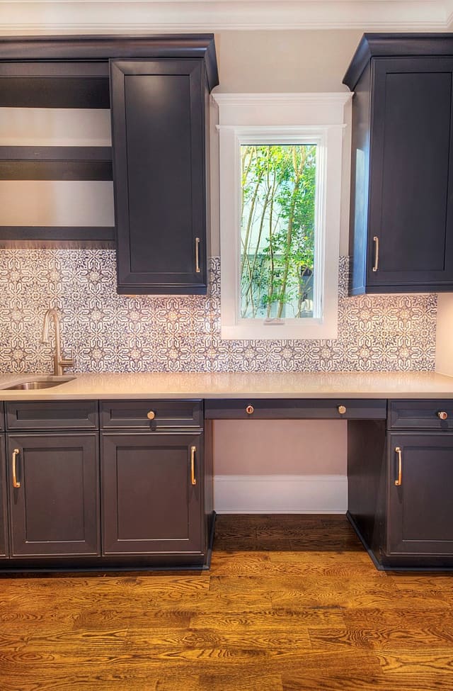 Butler's Pantry in new Raleigh home with gray cabinets and patterned tile backsplash