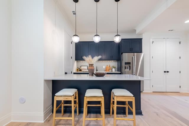 Basement kitchen with wood cushion barstools