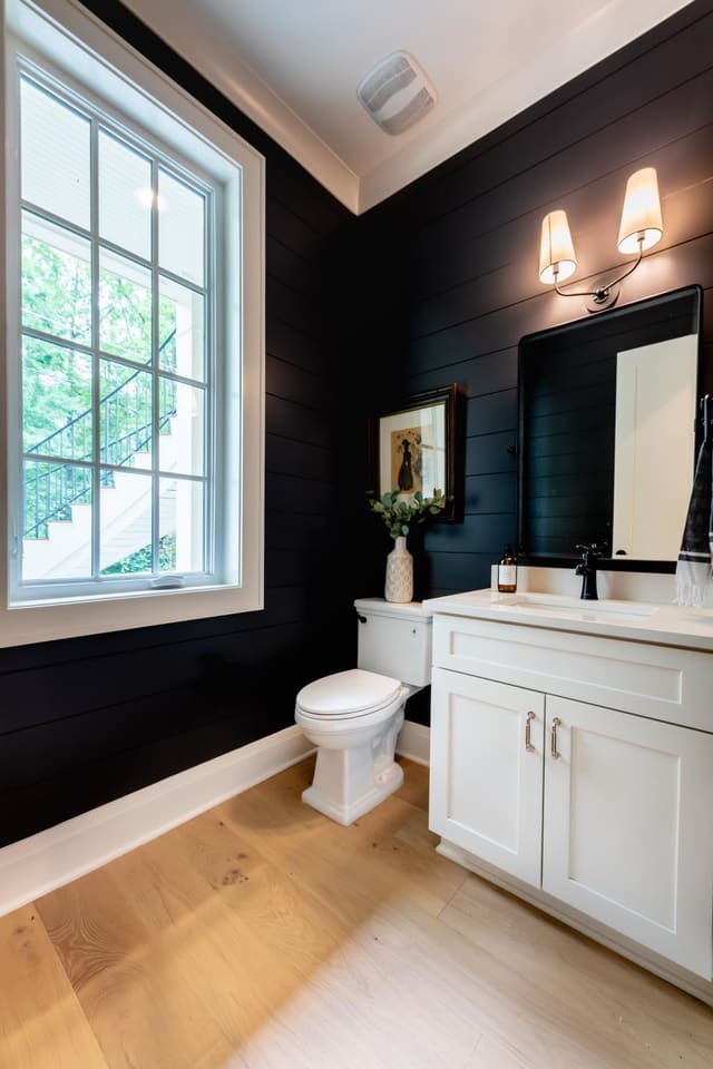 Bathroom with black paneled accent walls