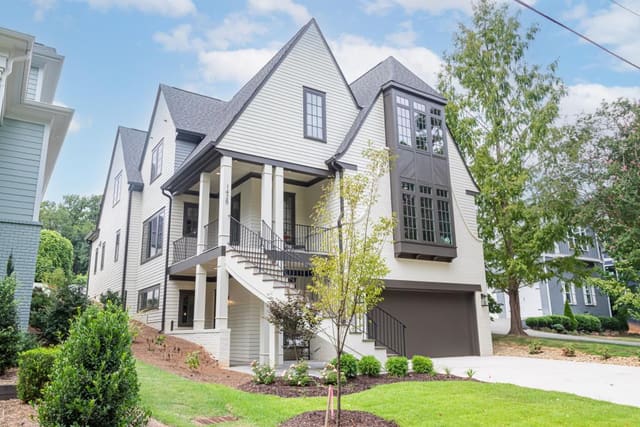 Home exterior with black railed staircase