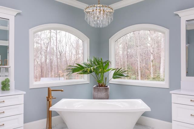 Master bathroom tub with Visual Comfort chandelier overtop.