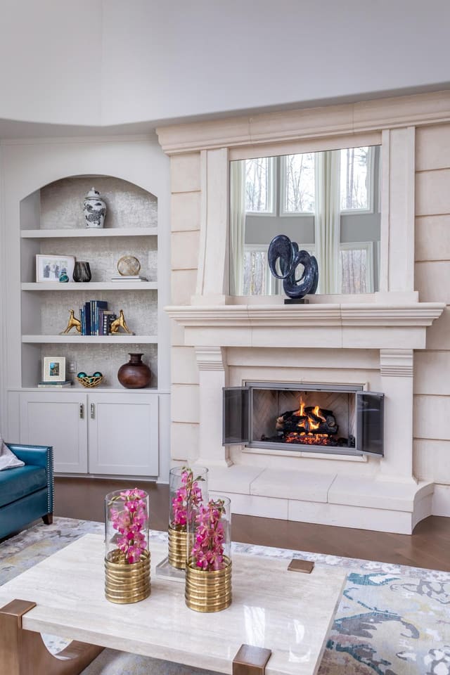 Family room with fresh flowers and a fireplace.