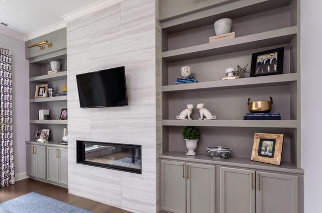 Decorated built-in bookshelves and fireplace.