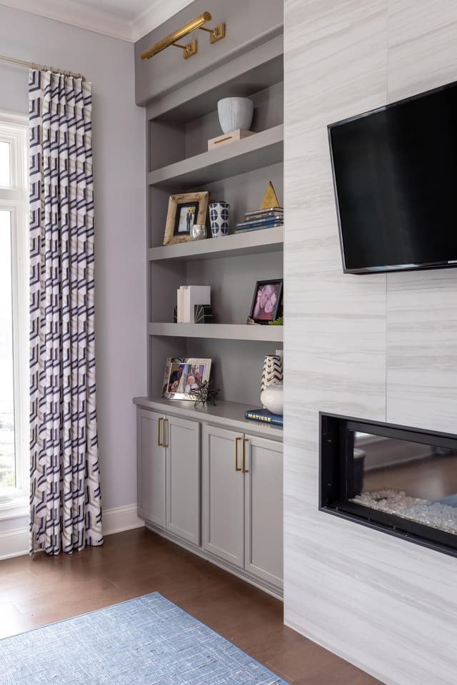 Decorated built-in bookshelves and fireplace.