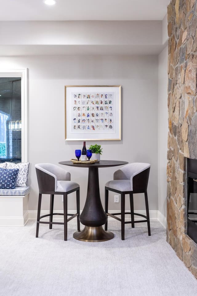 Two upholstered bar stools and table.