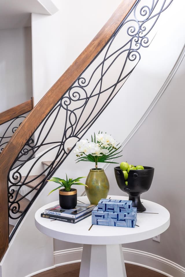 Decorative table at the bottom of the stairs leading into the basement.