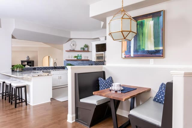 Basement kitchen and booth seating with Visual Comfort light.
