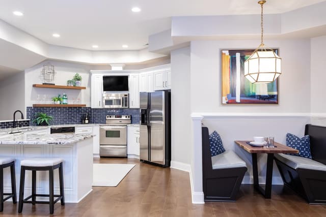 Basement kitchen and booth seating with Visual Comfort light.