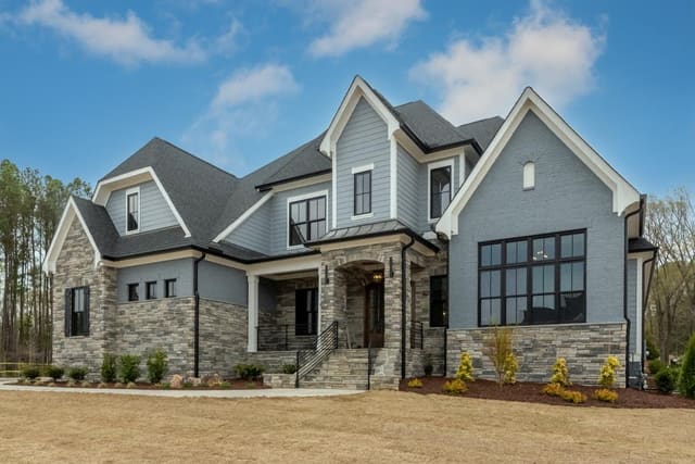 Exterior of Home with Brown Stone and Gray Siding