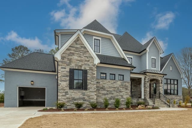 Exterior of Home with Brown Stone and Gray Siding