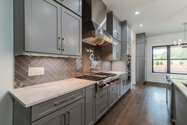 Kitchen Stovetop with Gray Patterened Backsplash