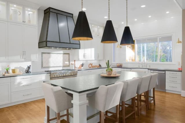 Wake Forest Kitchen with custom metal range hood and black and gold pendants