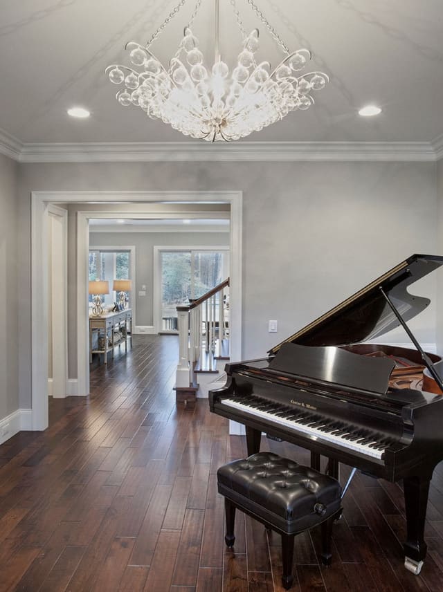 Piano Room in Wake Forest Home with funky light fixture