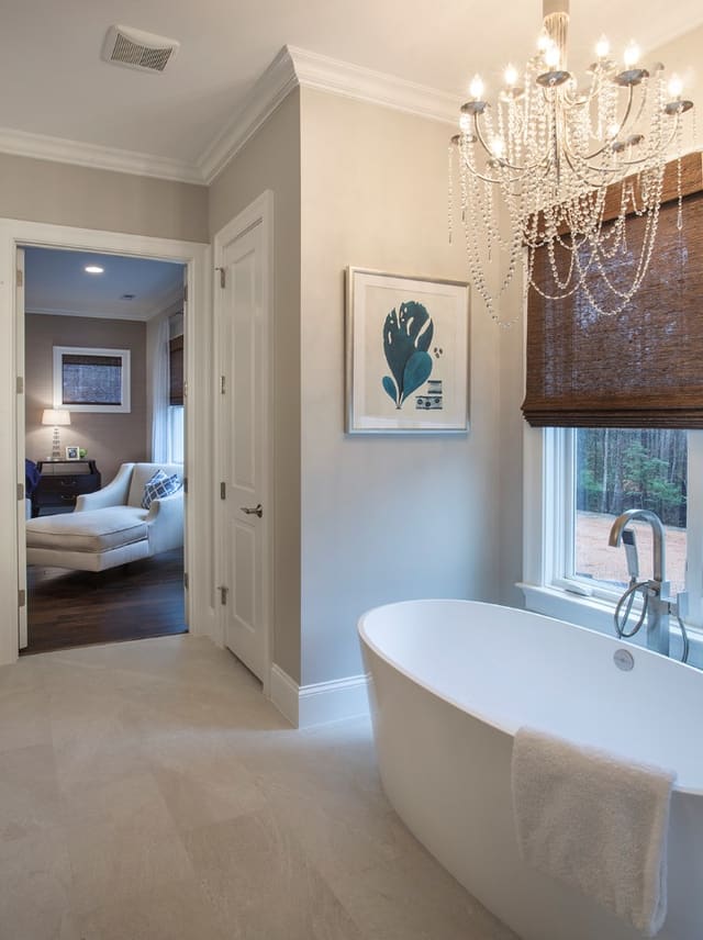 Tub in Master bathroom with crystal chandelier
