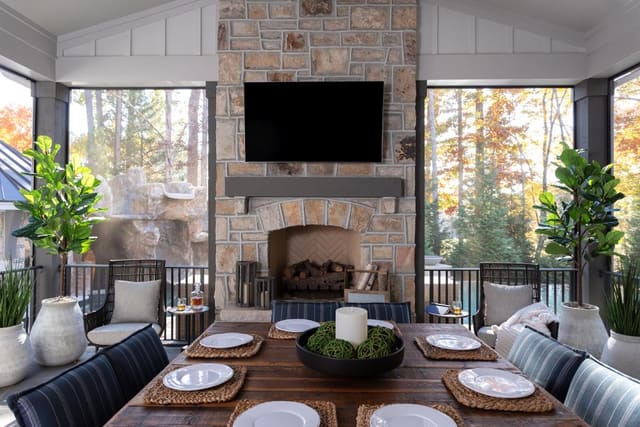 Outdoor Dining Space with Rustic Fireplace and Greenery
