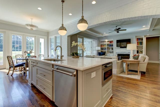 Kitchen with large island and globe pendants looking into Family Room