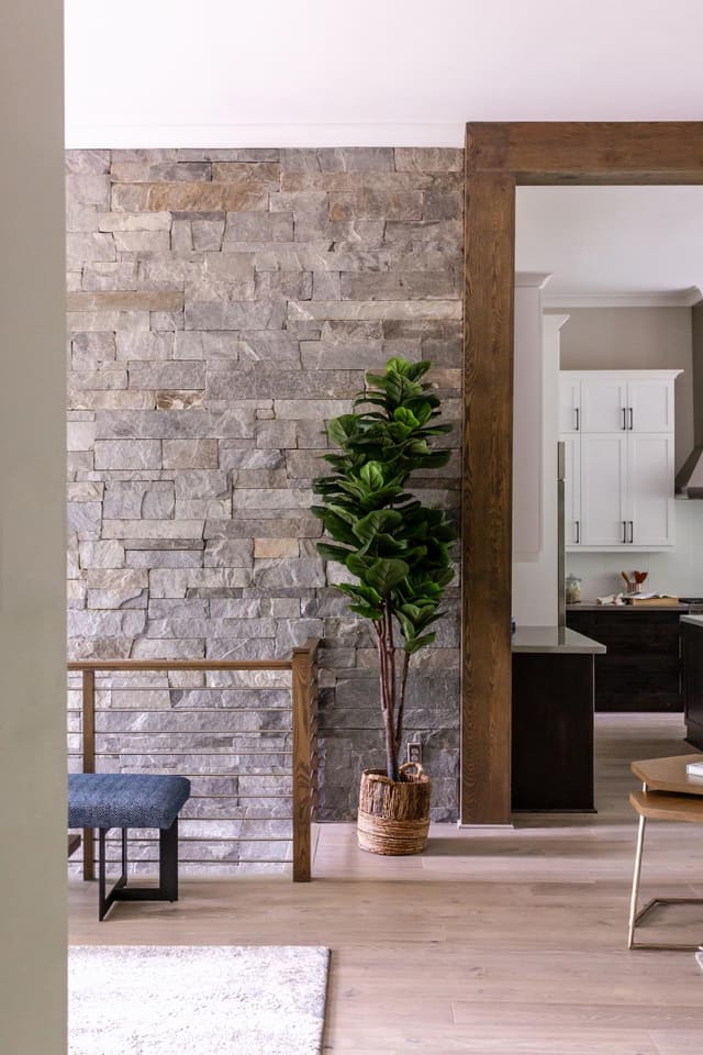 Stone Accent Wall Leading Down Staircase